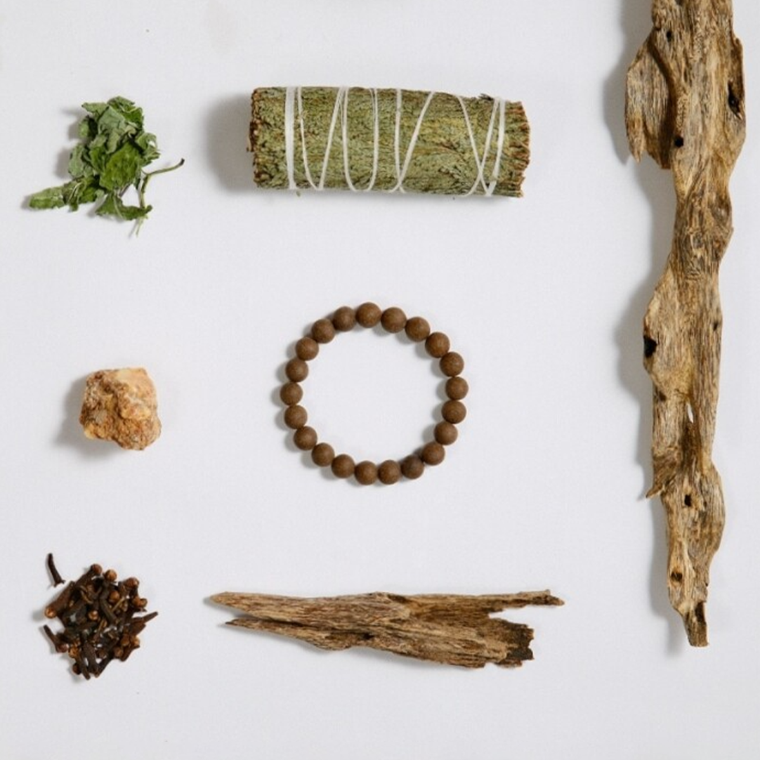 Aura Vegetarian Series picture: incense beads strings displayed side by side, surrounded by herbal materials, studio shot on a pure white background with soft light and shadow.